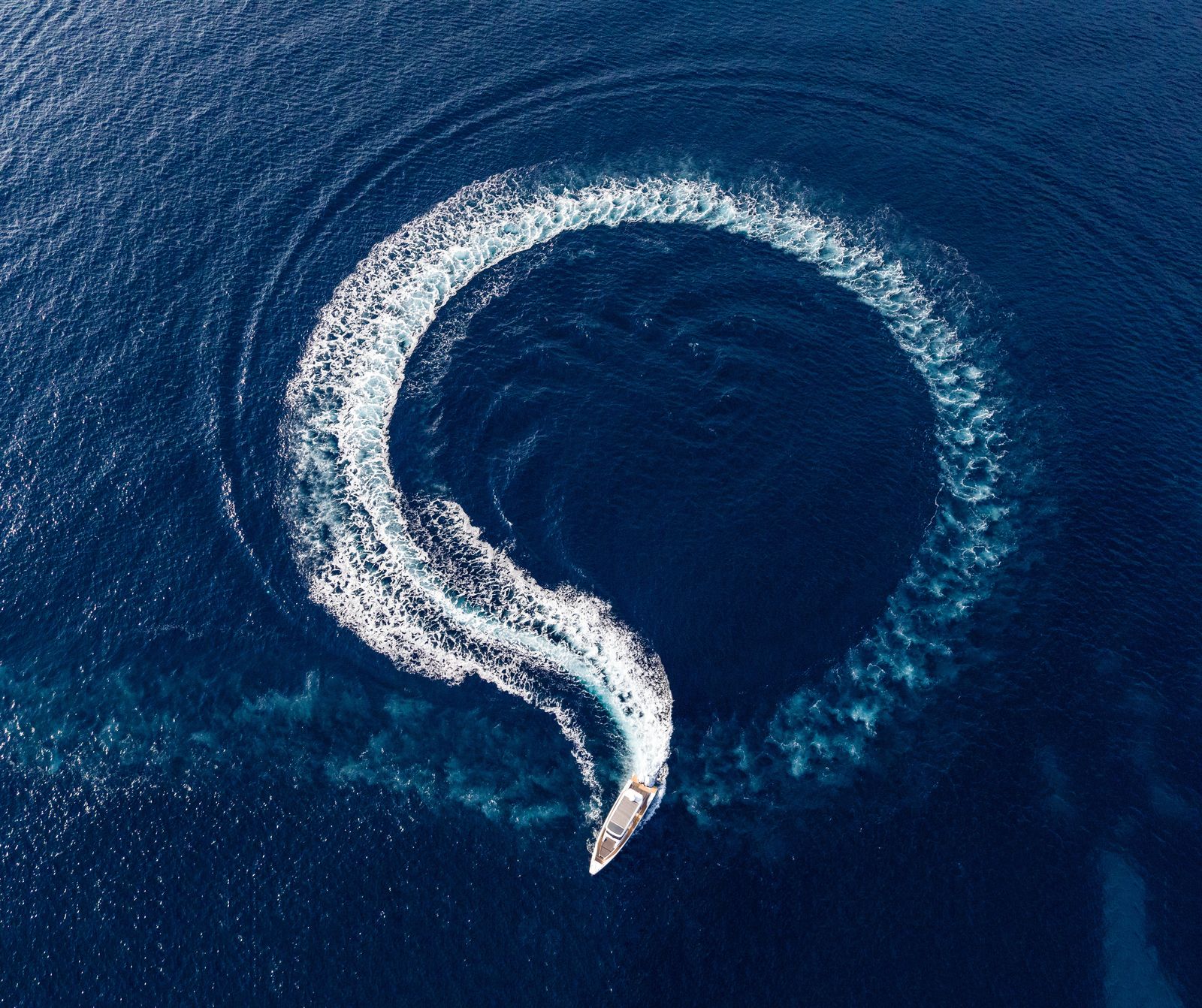 Aerial view of Axopar 37 luxury boat charter cruising Mediterranean waters off Mallorca