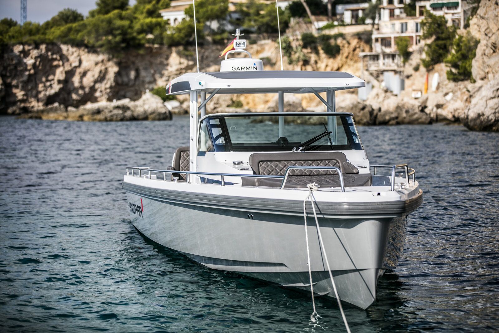 Axopar 37 charter boat anchored in scenic Mallorca cove