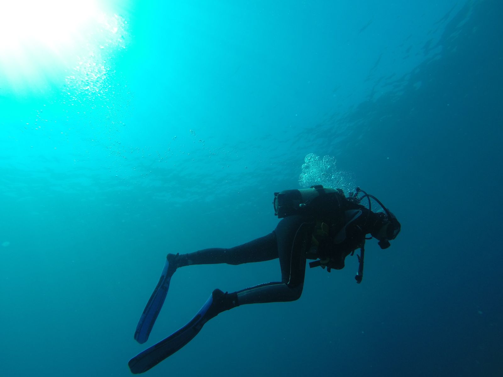 Diver exploring crystal clear waters at hidden Mallorca cove