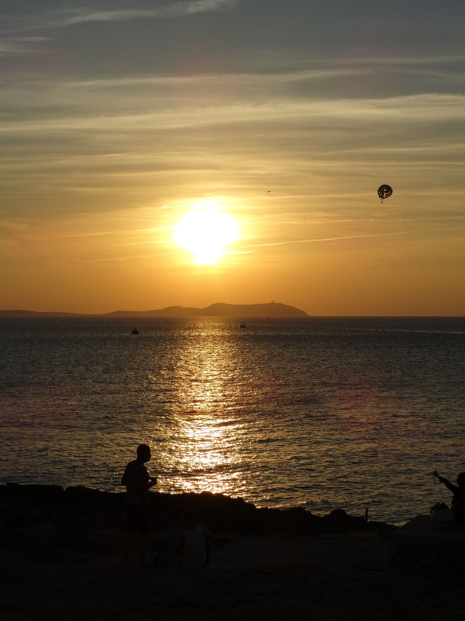 Golden sunset over the Mediterranean sea with island silhouettes on the horizon